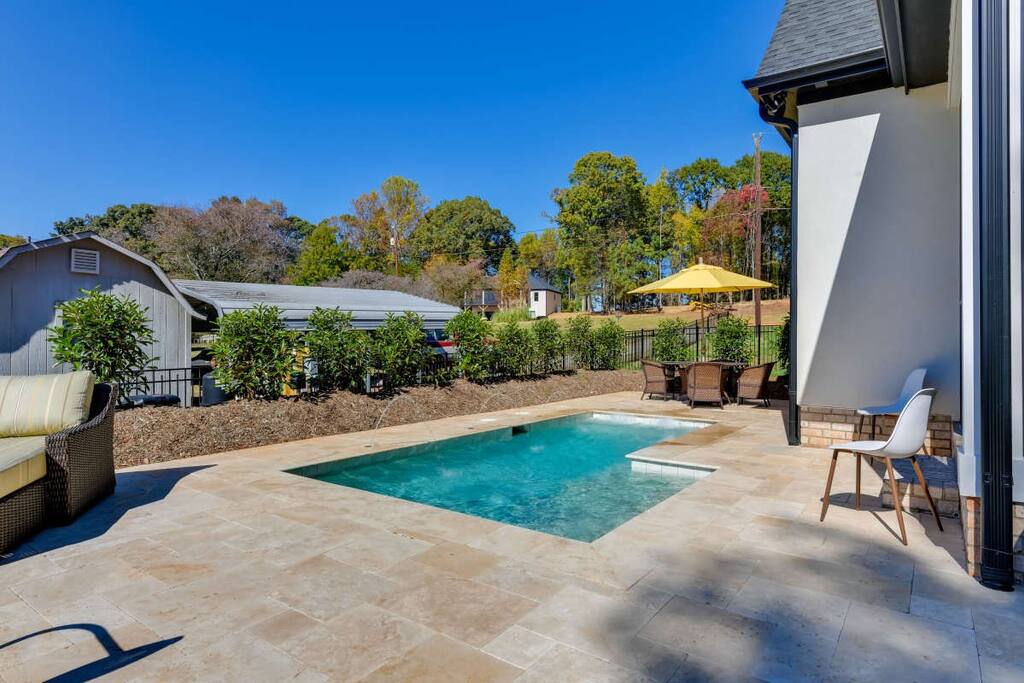 The travertine pool terrace at The Retreat at Lake Norman, a managed lakefront home